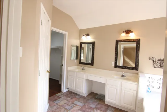 a bathroom with 2 sink and a mirror