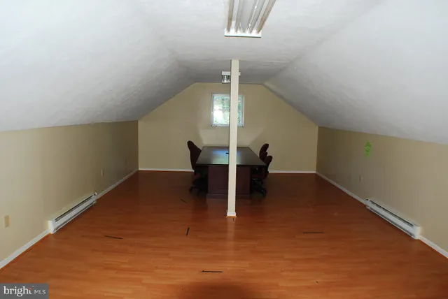 a view of a livingroom with furniture nad wooden floor
