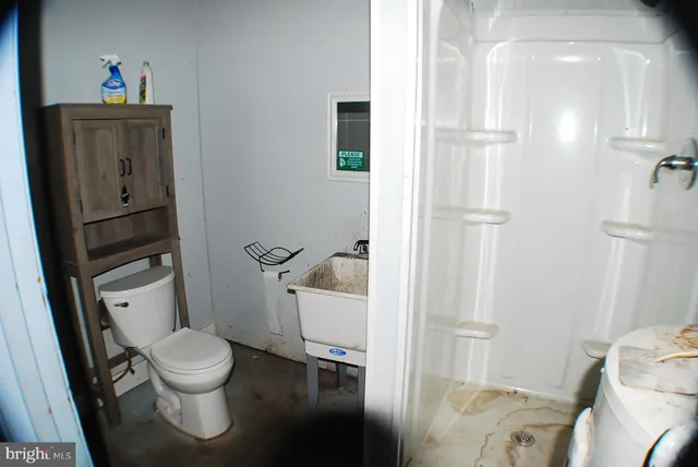 a white toilet sitting next to a bathroom sink