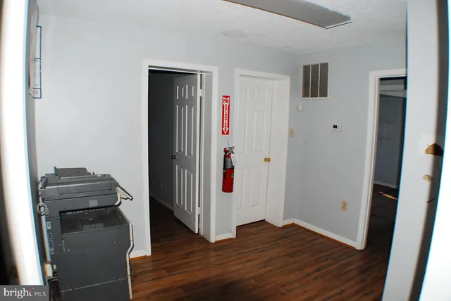 a view of a livingroom with wooden floor and entryway