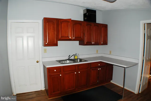 a kitchen with sink and cabinets