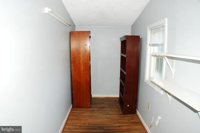 a view of hallway with wooden floor