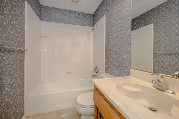 a bathroom with a sink a toilet and a bathtub