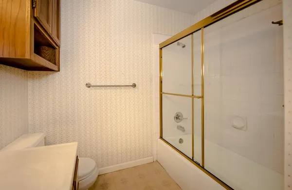 a bathroom with a shower and a toilet