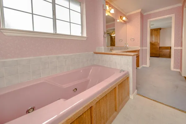 a bathroom with a tub and a sink