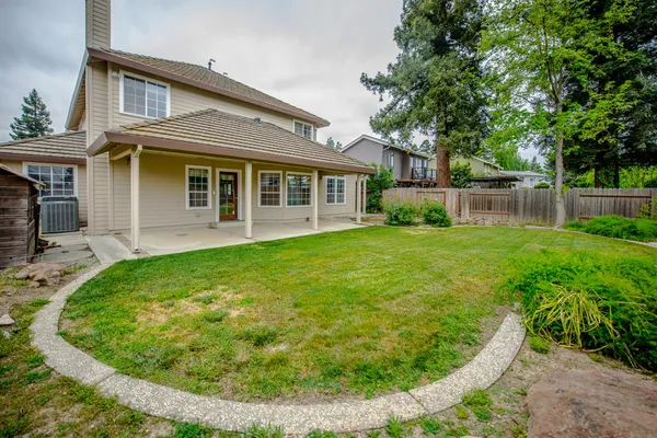 a view of a house with a backyard porch and sitting area