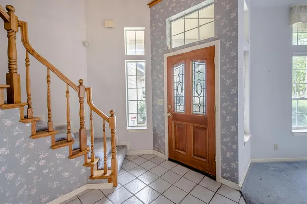 a view of an entryway with wooden floor and stairs