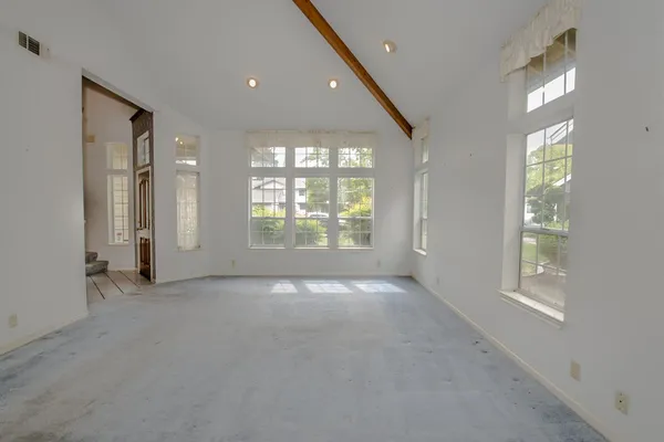 an empty room with windows and entrance