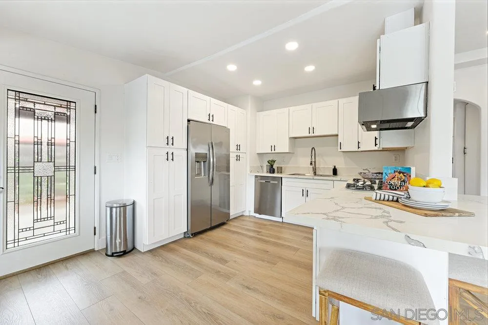 720 Valley Avenue Solana Beach, CA 92075 - Photo 2 of 12 a kitchen with stainless steel appliances a refrigerator sink and cabinets