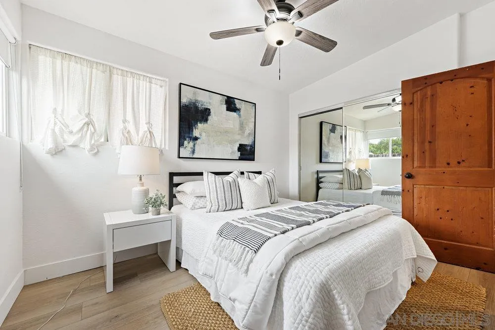 720 Valley Avenue Solana Beach, CA 92075 - Photo 6 of 12 a bedroom with a bed and a chandelier