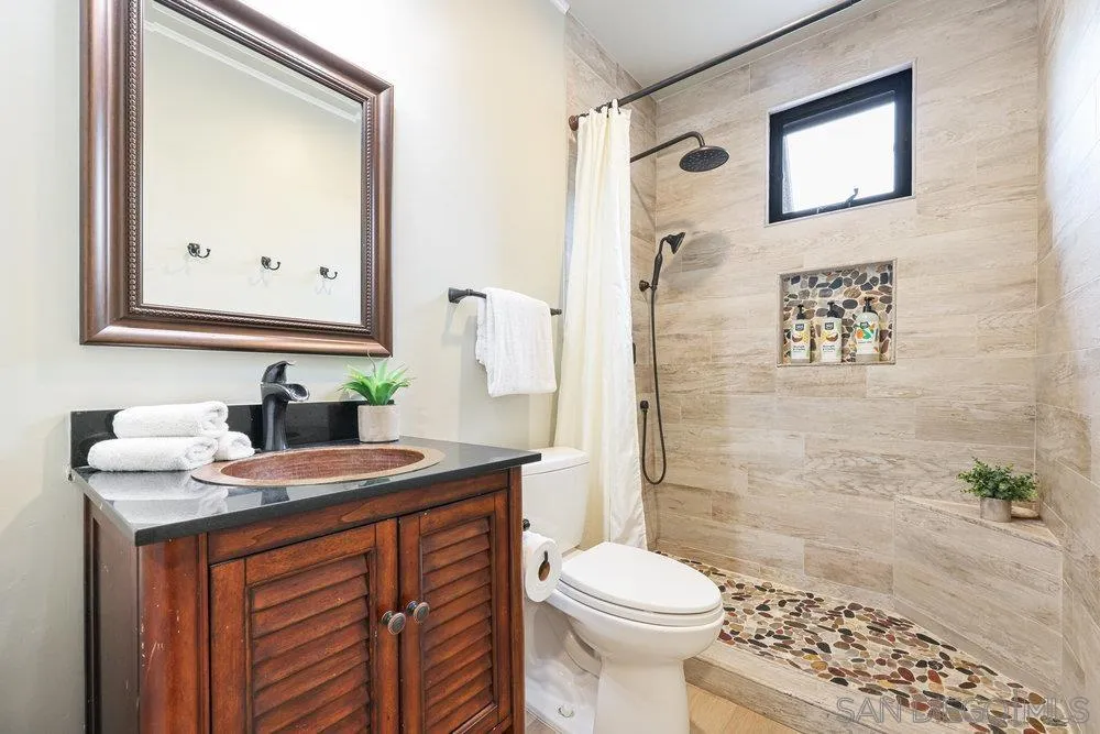 720 Valley Avenue Solana Beach, CA 92075 - Photo 7 of 12 a bathroom with a sink a toilet and shower