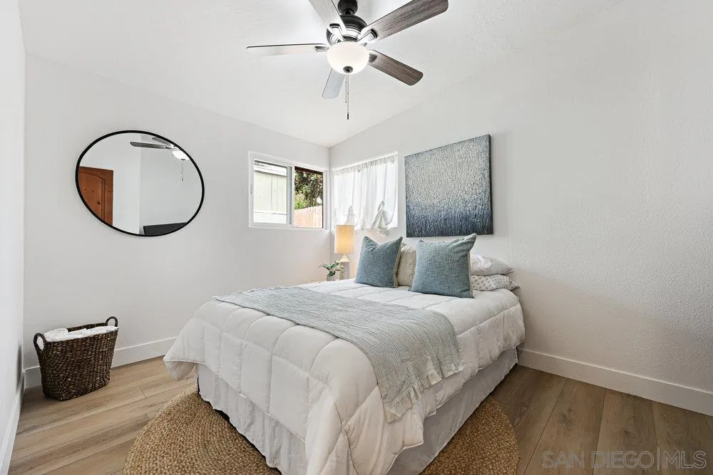 720 Valley Avenue Solana Beach, CA 92075 - Photo 8 of 12 a bedroom with bed and a chandelier