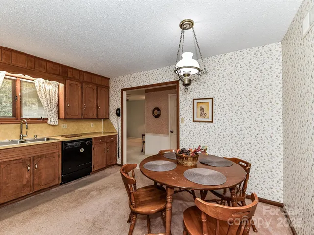 a kitchen with stainless steel appliances a sink and a table