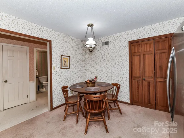 a dining room with furniture and window