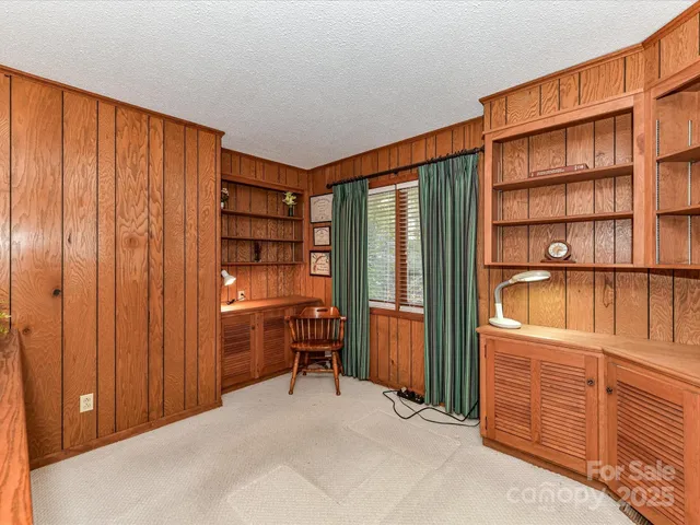 a view of a bedroom with furniture and wooden closet