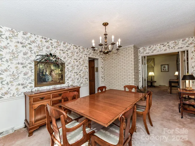 a view of a dining room with furniture and chandelier