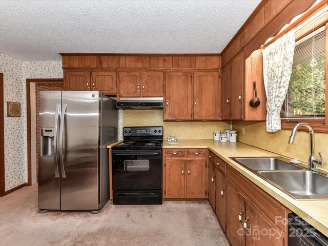 a kitchen with a sink appliances and cabinets