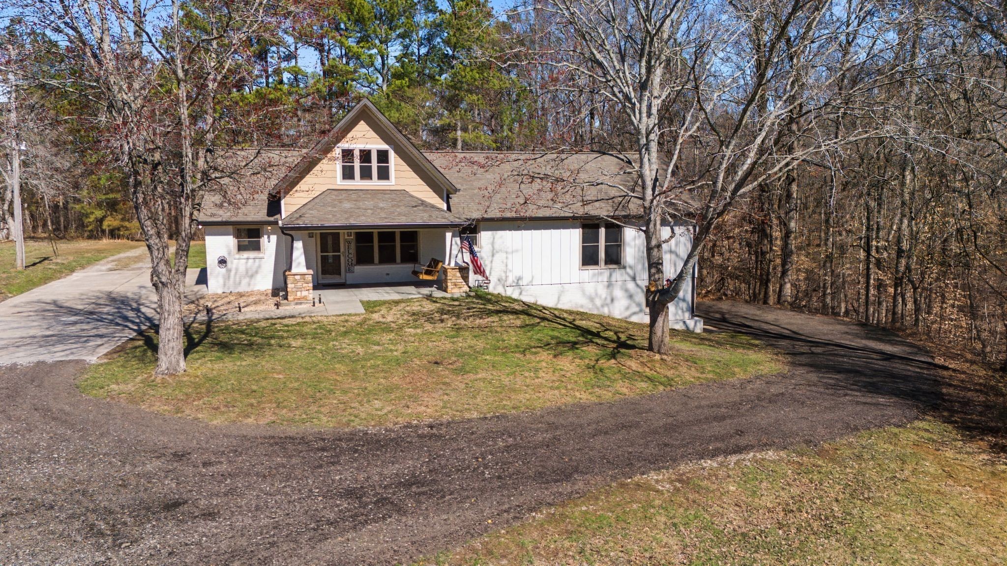 1231 Abiff Road Bon Aqua, TN 37025 - Photo 51 of 60 a house with large trees in front of it