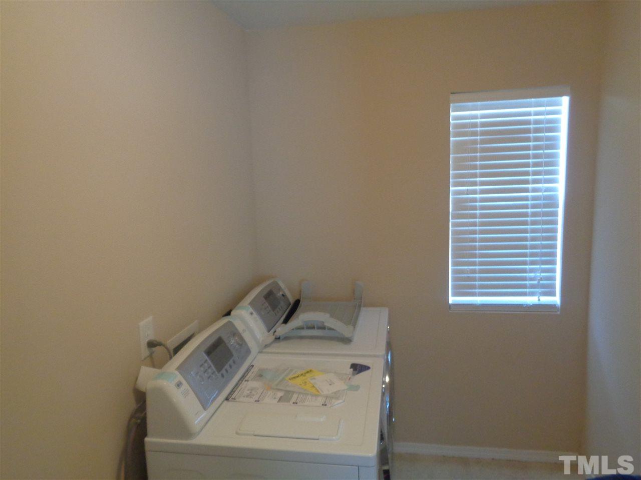 3033 Varcroft Road Knightdale, NC 27545 - Photo 14 of 16 a utility room with dryer and washer