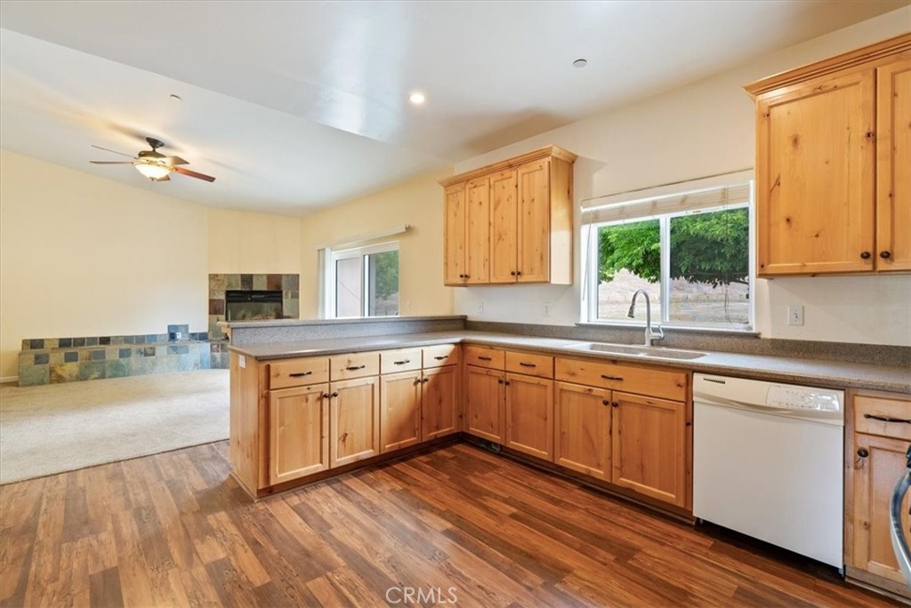 76846 Ranchita Canyon Road San Miguel, CA 93451 - Photo 13 of 51 a kitchen with stainless steel appliances granite countertop wooden floors a stove top oven a sink and dishwasher with wooden floor