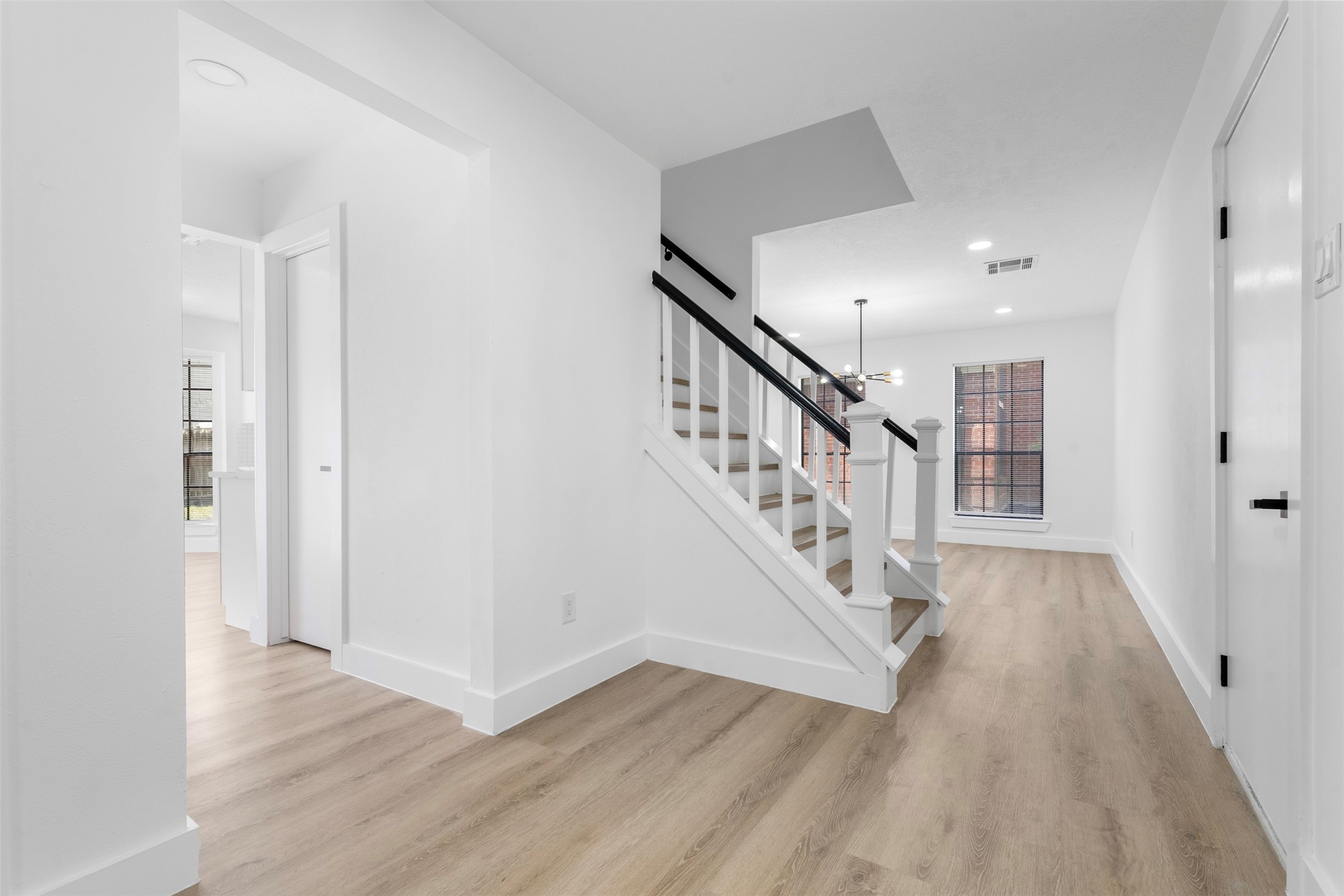 14922 Waybridge Drive Houston, TX 77062 - Photo 9 of 49 a view of staircase with wooden floor and stairs