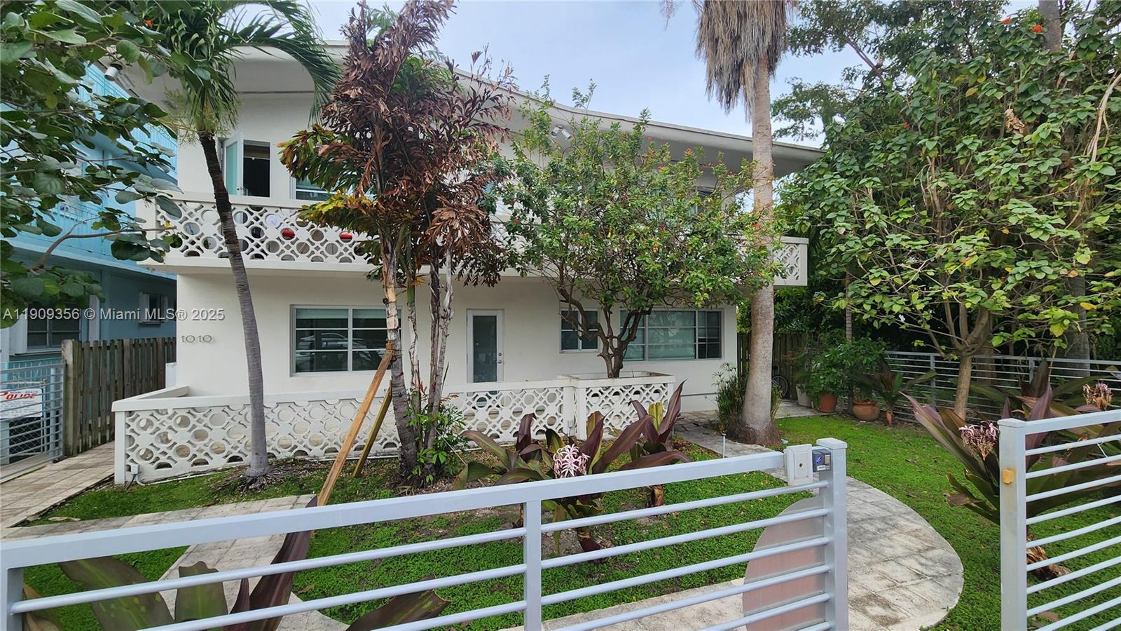 1010 Pennsylvania Avenue, Unit 14 Miami Beach, FL 33139 - Photo 1 of 8 a front view of a house with a yard table and chairs