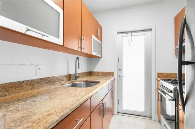 a kitchen with a sink and a refrigerator