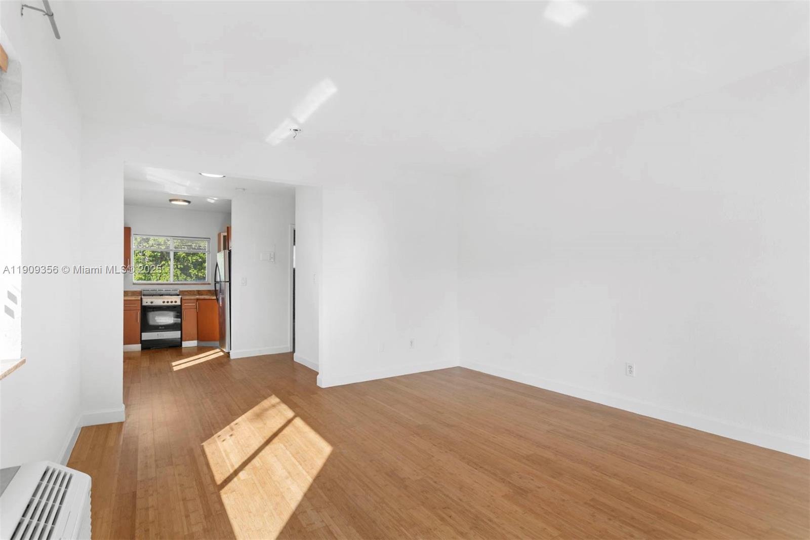 1010 Pennsylvania Avenue, Unit 14 Miami Beach, FL 33139 - Photo 3 of 8 a view of a bedroom with wooden floor and a window