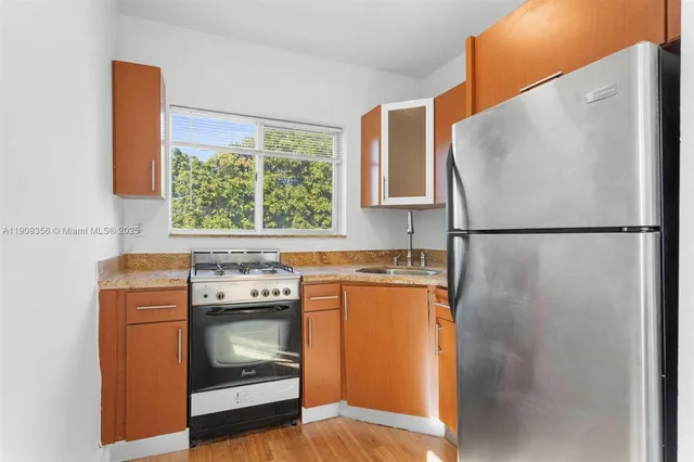 a kitchen with a stove and a refrigerator