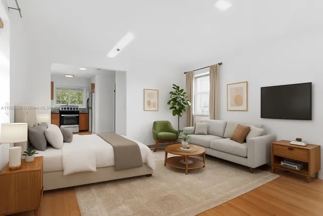 a bedroom with a bed a couch and a flat screen tv