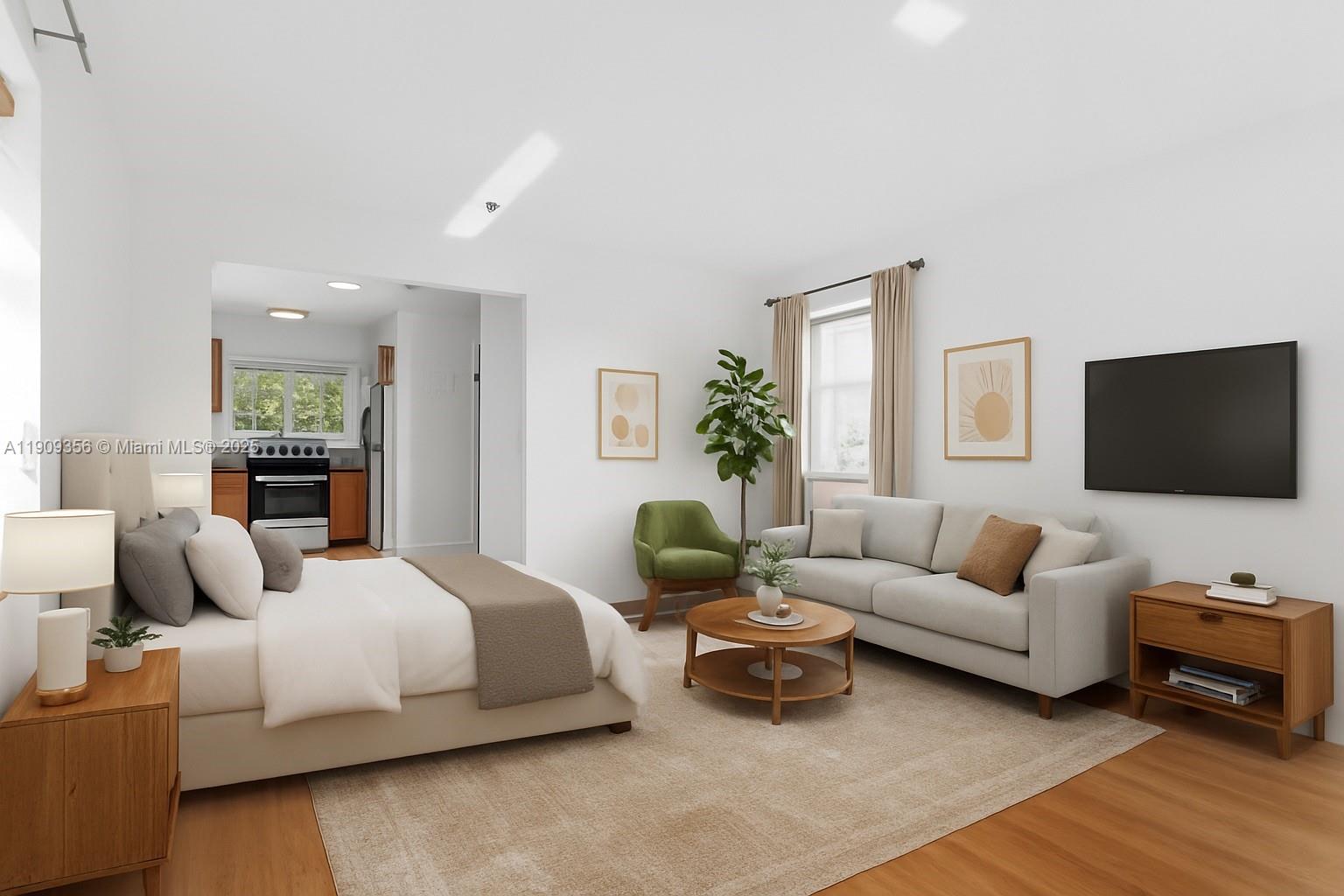 1010 Pennsylvania Avenue, Unit 14 Miami Beach, FL 33139 - Photo 6 of 8 a bedroom with a bed a couch and a flat screen tv