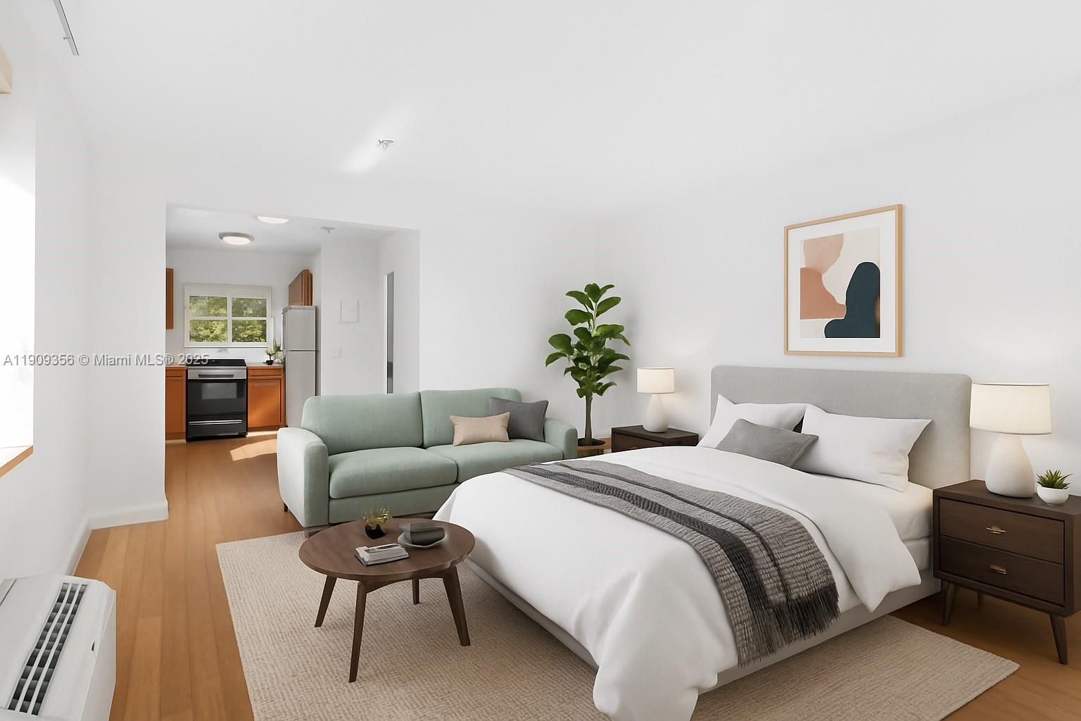 1010 Pennsylvania Avenue, Unit 14 Miami Beach, FL 33139 - Photo 8 of 8 a bedroom with a bed and a couch