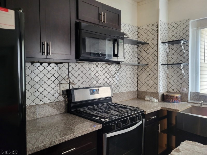 258 Chambers Street Phillipsburg, NJ 08865 - Photo 4 of 9 a kitchen with stainless steel appliances granite countertop a stove a sink and a microwave