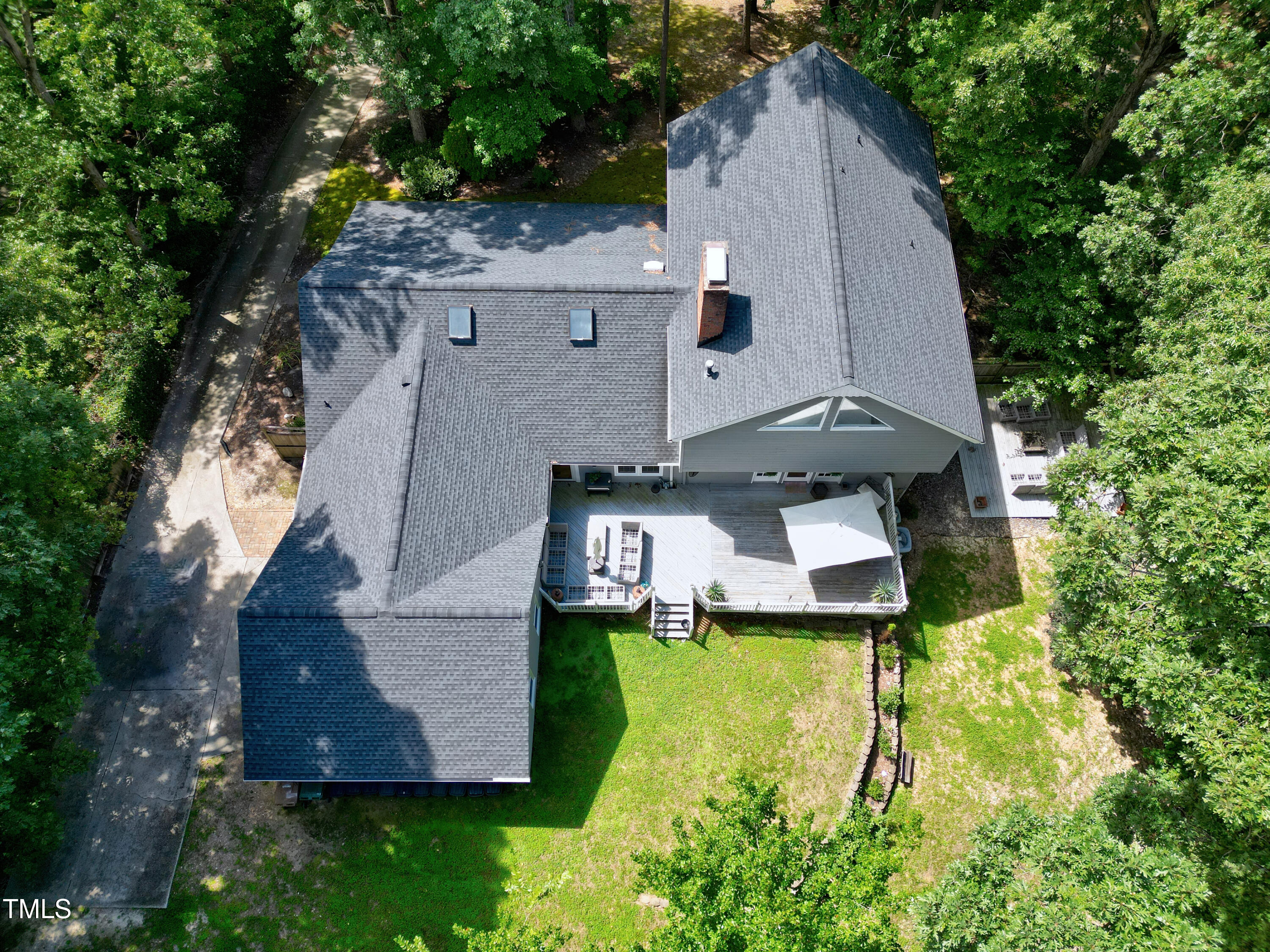 an aerial view of a house with swimming pool and garden