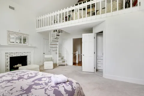 a bedroom with bed and a fireplace