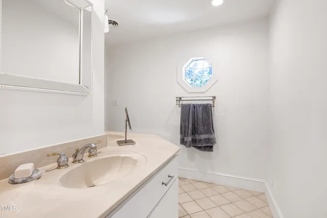 a bathroom with a sink a vanity and a mirror
