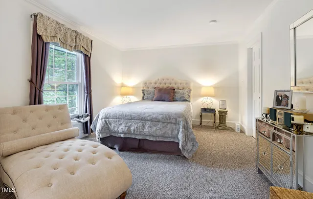 a bedroom with a bed a couch and dresser