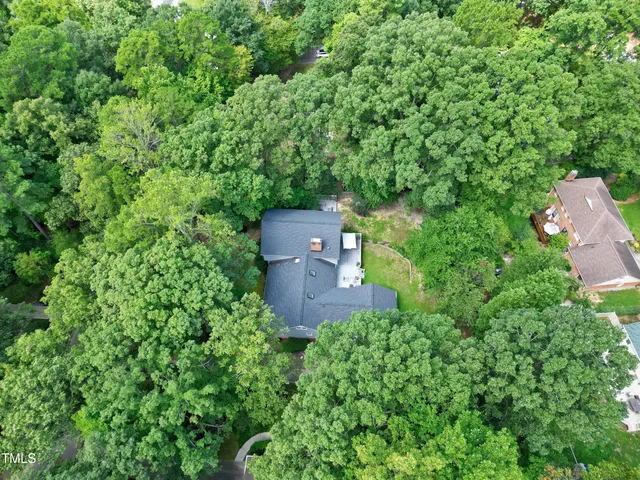 an aerial view of a house with a yard
