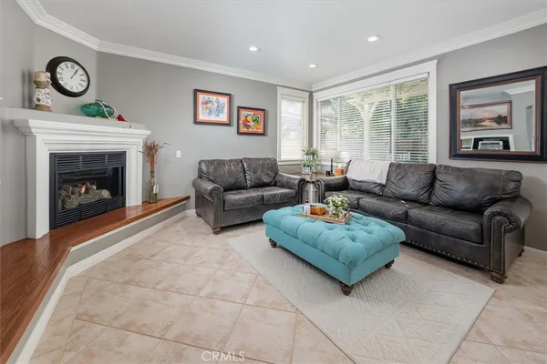 a living room with furniture a large window and a fireplace