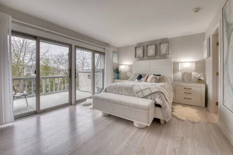 a bedroom with a large bed and a large window