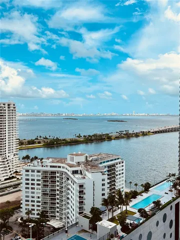 a view of a lake with tall buildings
