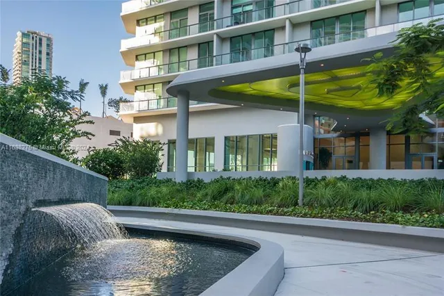 a view of a backyard with plants and a patio