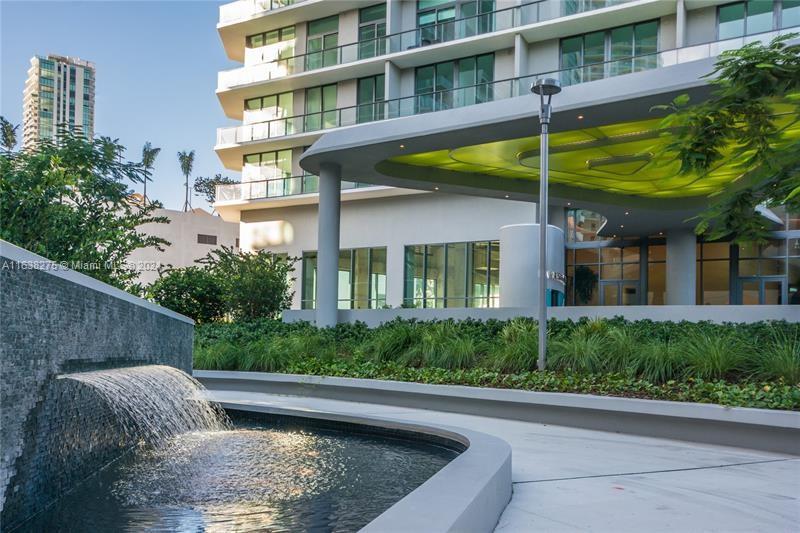 501 Northeast 31st Street, Unit 2204 Miami, FL 33137 - Photo 17 of 26 a view of a backyard with plants and a patio