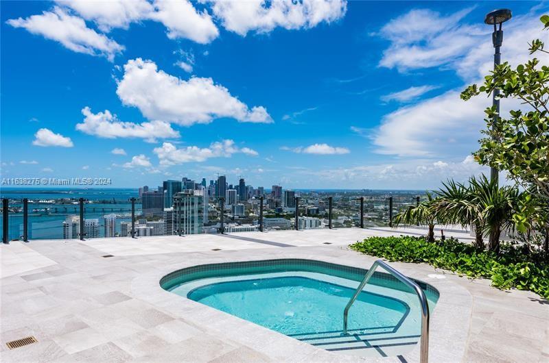 501 Northeast 31st Street, Unit 2204 Miami, FL 33137 - Photo 23 of 26 a swimming pool with trees in the background