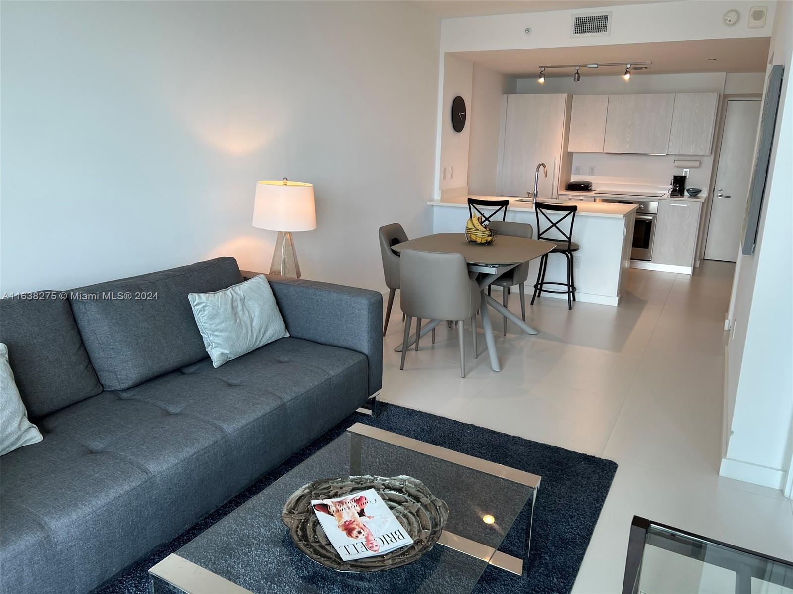 501 Northeast 31st Street, Unit 2204 Miami, FL 33137 - Photo 7 of 26 a living room with furniture and a wooden floor