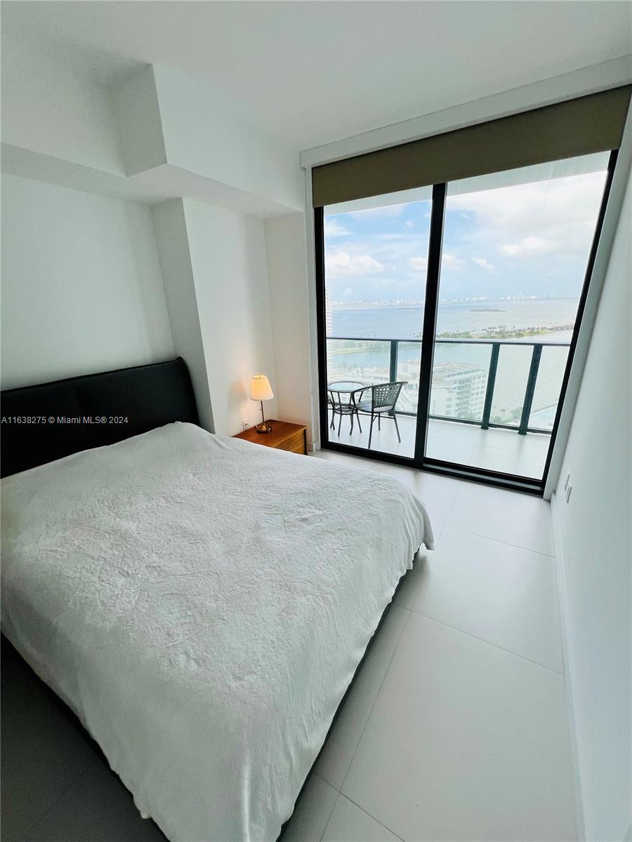 501 Northeast 31st Street, Unit 2204 Miami, FL 33137 - Photo 10 of 26 a bedroom with a bed and a large window