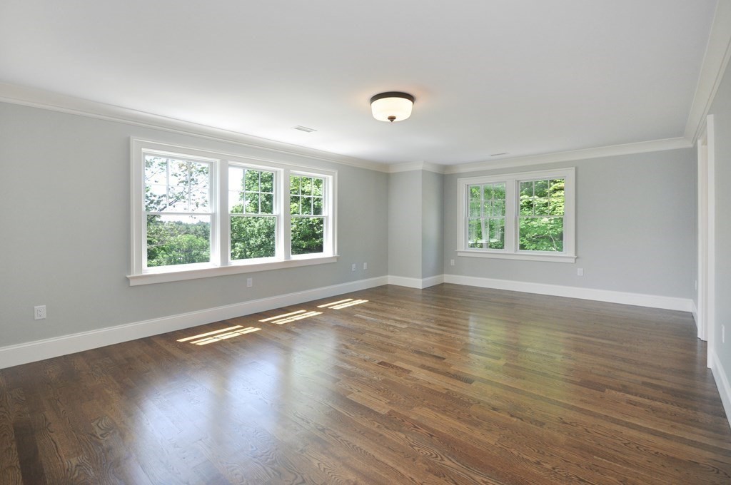 248 Nashawtuc Road Concord, MA 01742 - Photo 19 of 38 an empty room with wooden floor and windows