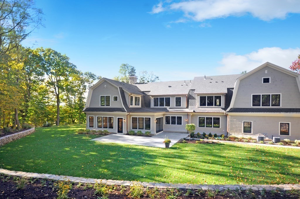 248 Nashawtuc Road Concord, MA 01742 - Photo 2 of 38 a front view of a house with a garden