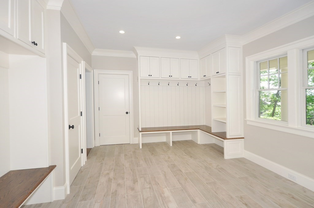 248 Nashawtuc Road Concord, MA 01742 - Photo 23 of 38 a view of an empty room with wooden floor and a window