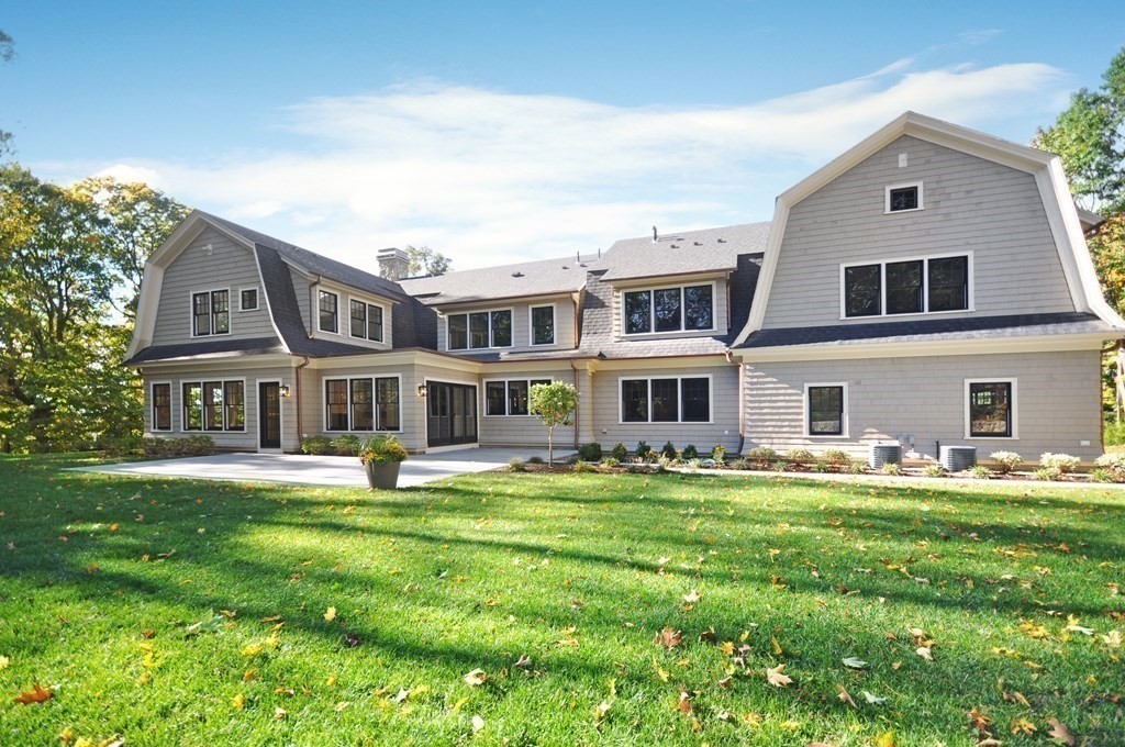 248 Nashawtuc Road Concord, MA 01742 - Photo 26 of 38 a front view of a house with a garden and trees